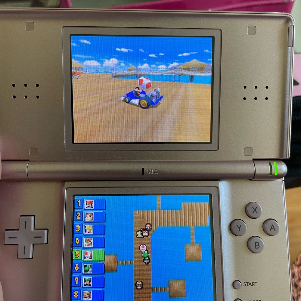 Nintendo DS with games, accessories, charger, and carrying case
